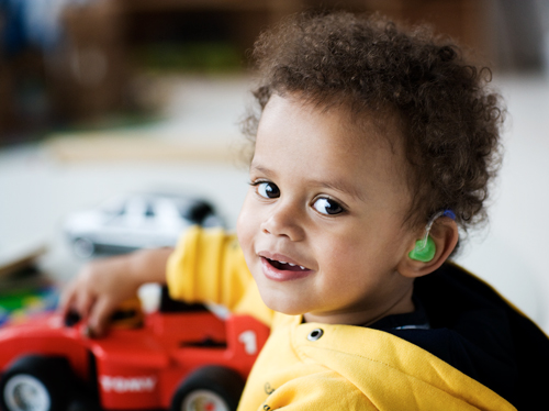 a boy wearing a cochlear implant